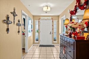 Tiled entry hallway of the assisted living home, warmly decorated with a view into the living area