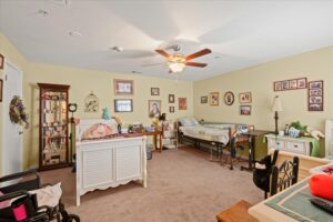 Furnished resident bedroom with a care bed and personal decor at the Round Rock assisted living home