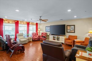 Comfortable living room with recliners, armchairs, and a large-screen television
